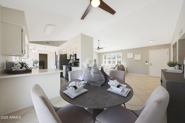 dining space featuring visible vents, light tile patterned floors, ceiling fan, and vaulted ceiling