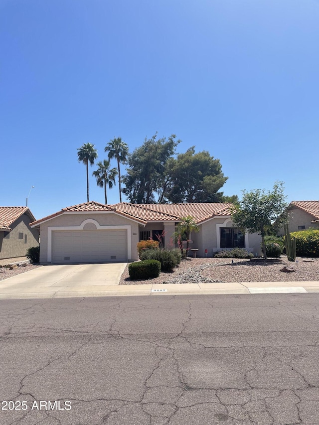9807 W Mcrae Way, Peoria, AZ 85382 - single story home with an attached garage, a tiled roof, stucco siding, and concrete driveway