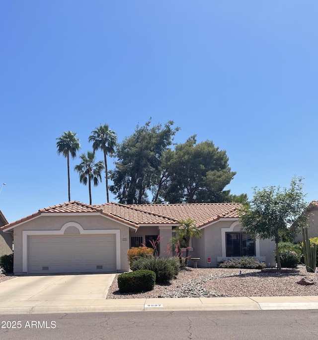 9807 W Mcrae Way, Peoria, AZ 85382 - view of front of home featuring an attached garage, a tiled roof, stucco siding, and concrete driveway