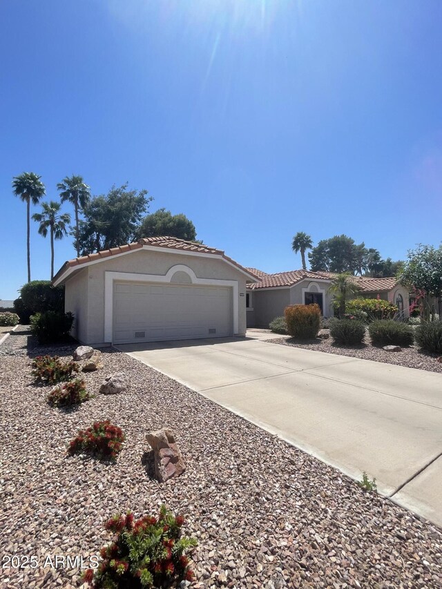 9807 W Mcrae Way, Peoria, AZ 85382 - view of front facade with driveway, stucco siding, a tiled roof, and an attached garage