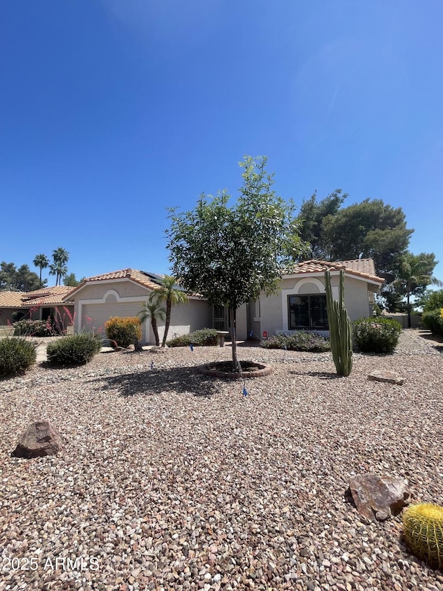 9807 W Mcrae Way, Peoria, AZ 85382 - view of front of house featuring a tiled roof, stucco siding, solar panels, and a garage