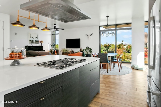 kitchen featuring pendant lighting, ceiling fan, light wood-type flooring, and extractor fan