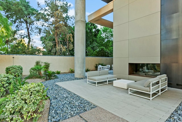 view of patio featuring an outdoor living space with a fireplace