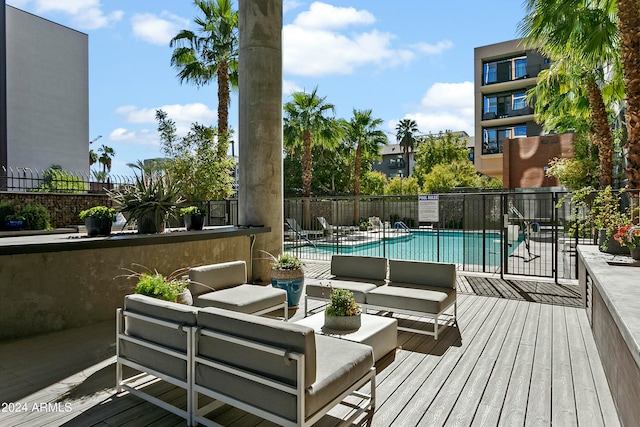 view of pool featuring outdoor lounge area, a patio, and a wooden deck