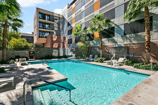 view of swimming pool featuring a patio area