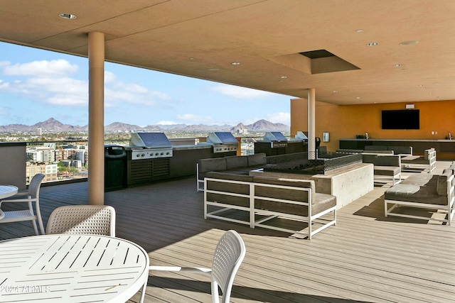 wooden terrace featuring outdoor lounge area, a mountain view, area for grilling, and grilling area