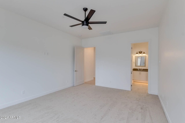 unfurnished room with light carpet, sink, and ceiling fan