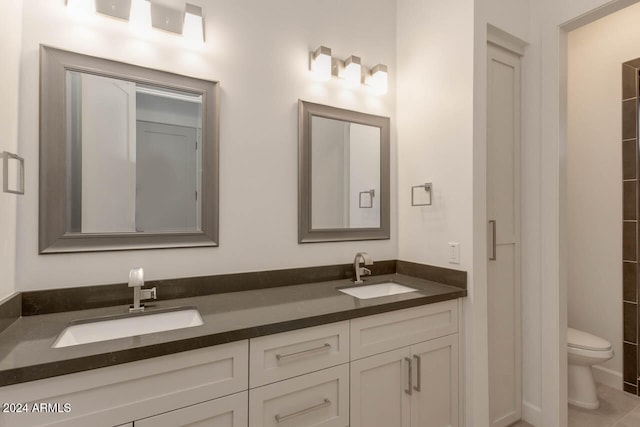 bathroom featuring vanity, toilet, and tile patterned floors