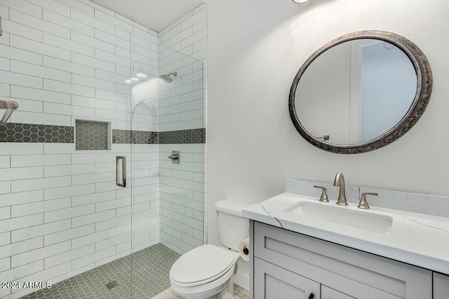 bathroom featuring toilet, walk in shower, and vanity