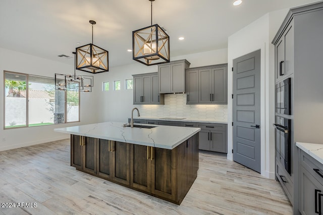 kitchen with a center island with sink, sink, and a kitchen breakfast bar