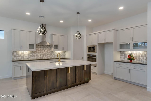 kitchen with appliances with stainless steel finishes, sink, decorative light fixtures, and decorative backsplash