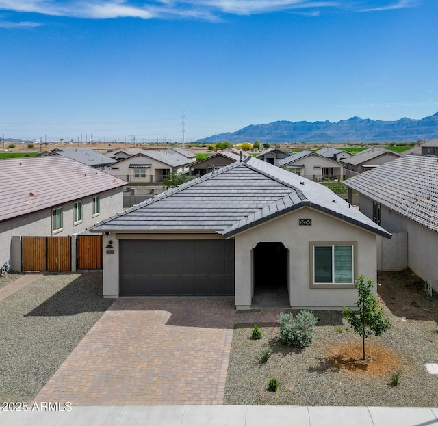 ranch-style house with stucco siding, a residential view, and an attached garage