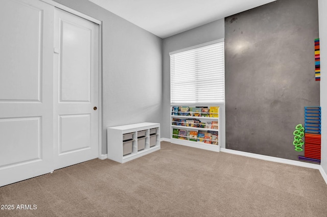 playroom with baseboards and carpet