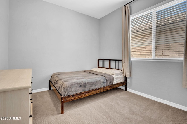 bedroom featuring baseboards and carpet flooring
