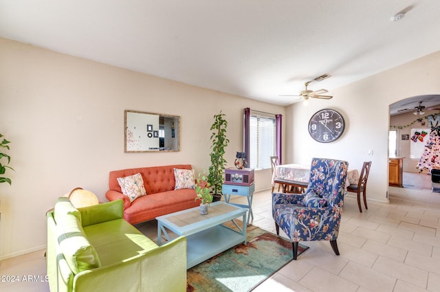 living room featuring ceiling fan and light tile patterned flooring