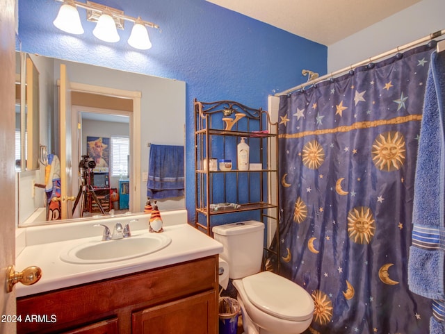 bathroom featuring vanity, a shower with shower curtain, and toilet