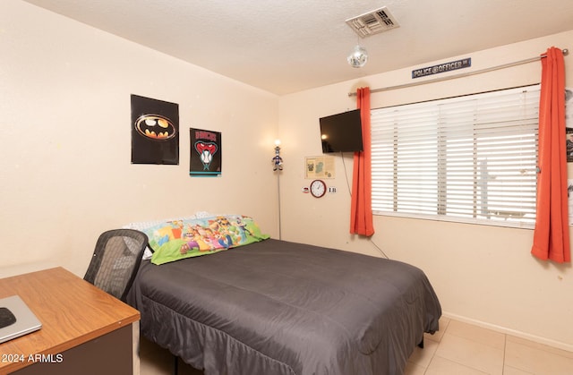 bedroom featuring a textured ceiling and light tile patterned flooring