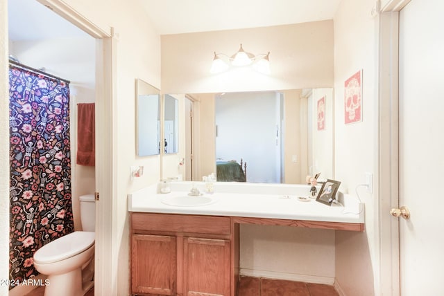 bathroom featuring tile patterned floors, vanity, and toilet