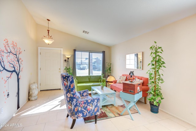 sitting room featuring light tile patterned floors and lofted ceiling