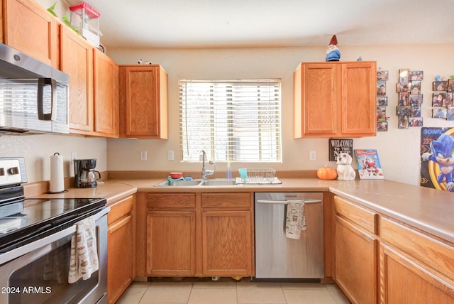 kitchen featuring light tile patterned floors, sink, and appliances with stainless steel finishes