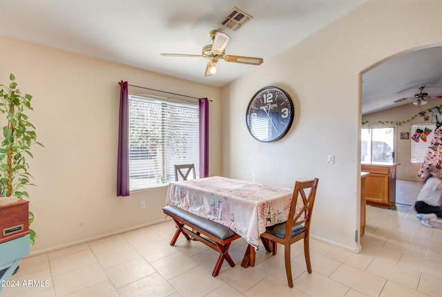 tiled dining space with a wealth of natural light and ceiling fan