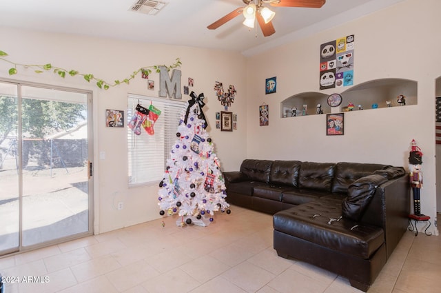 recreation room featuring vaulted ceiling, ceiling fan, and light tile patterned flooring