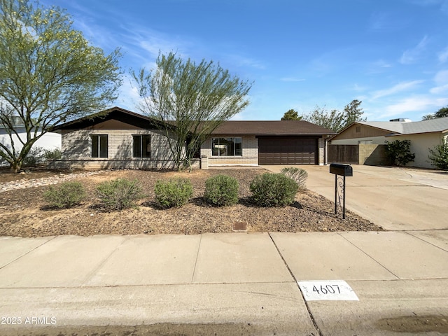 4607 W Becker Ln, Glendale, AZ 85304 - ranch-style house with concrete driveway, a garage, and brick siding