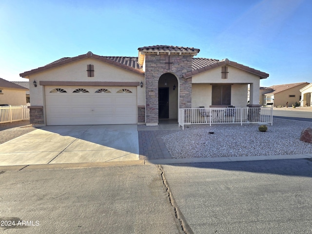 view of front of property with covered porch and a garage