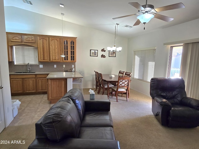 living room with light carpet, ceiling fan with notable chandelier, vaulted ceiling, and sink