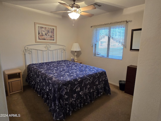 bedroom featuring ceiling fan and dark carpet