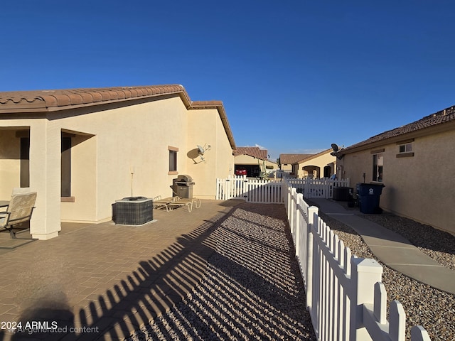 view of side of home featuring central AC and a patio area