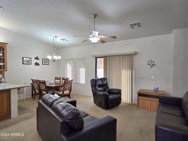 living room featuring ceiling fan with notable chandelier, light colored carpet, and lofted ceiling