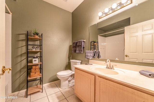 bathroom with toilet, a shower, vanity, and tile patterned floors