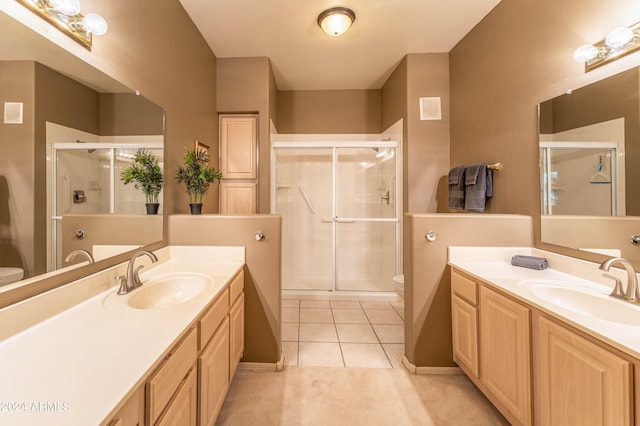 bathroom featuring vanity, toilet, and a shower with door