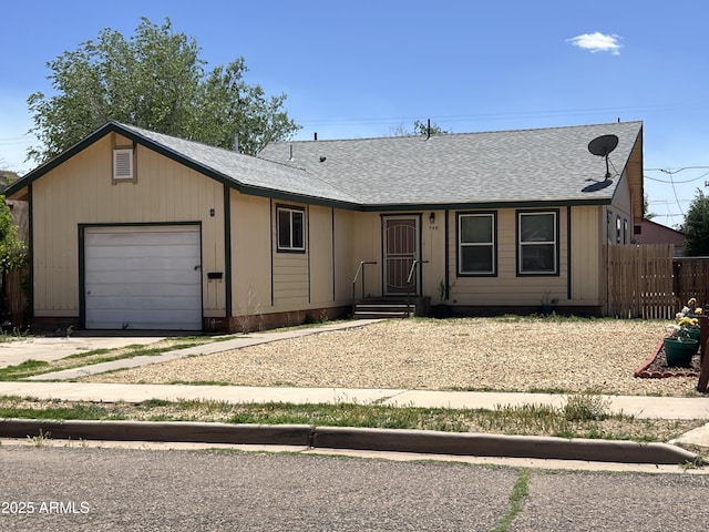 709 W Maple St, Winslow, AZ 86047 - single story home featuring a garage, fence, driveway, and a shingled roof