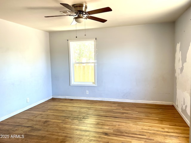 709 W Maple St, Winslow, AZ 86047 - spare room with wood finished floors, ceiling fan, and baseboards