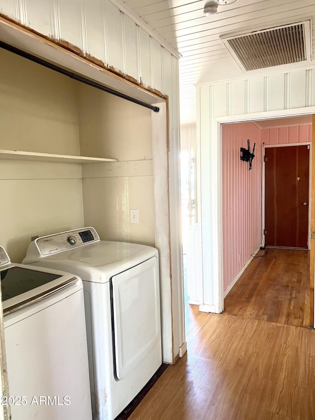 709 W Maple St, Winslow, AZ 86047 - clothes washing area featuring washing machine and clothes dryer and light wood-style flooring