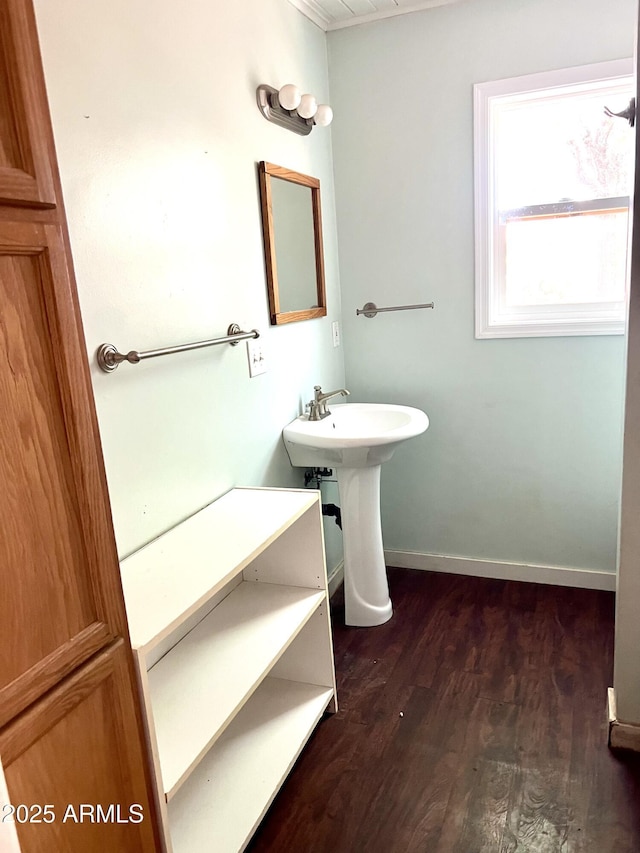 709 W Maple St, Winslow, AZ 86047 - bathroom featuring wood finished floors, baseboards, and a sink