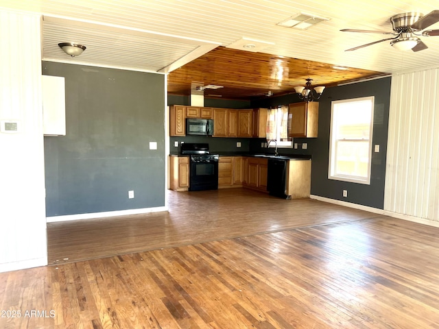 709 W Maple St, Winslow, AZ 86047 - kitchen with black appliances, dark countertops, a sink, and wood finished floors