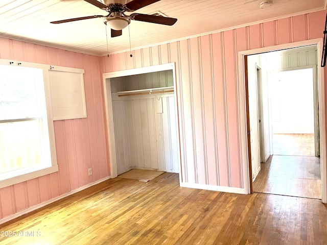 709 W Maple St, Winslow, AZ 86047 - unfurnished bedroom with hardwood / wood-style floors, a closet, baseboards, a ceiling fan, and crown molding