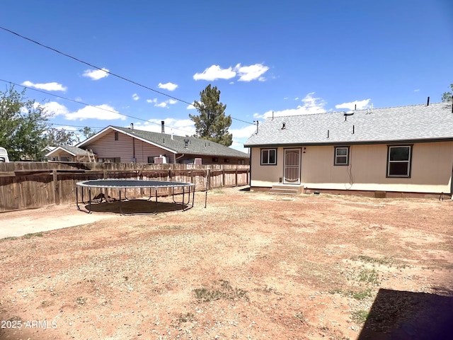 709 W Maple St, Winslow, AZ 86047 - fenced backyard with a trampoline