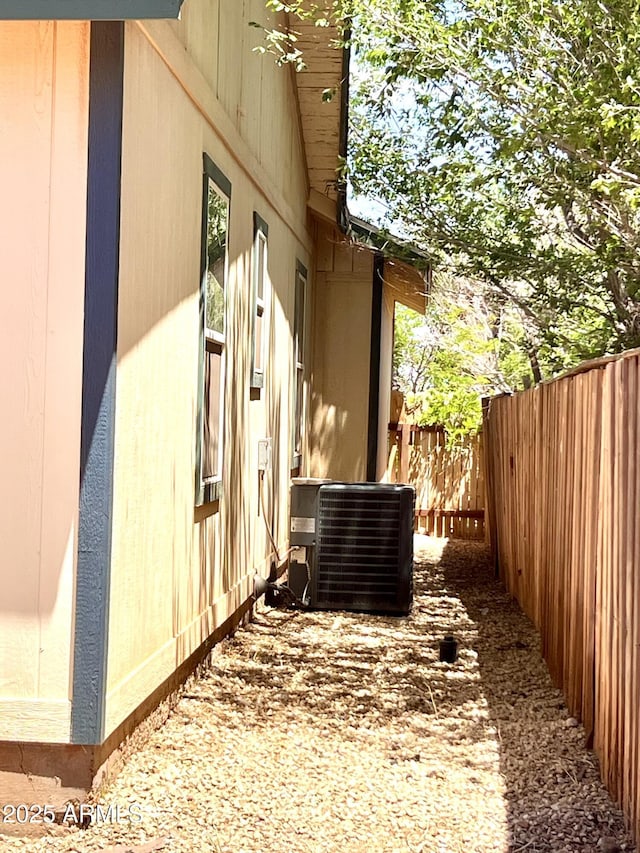 709 W Maple St, Winslow, AZ 86047 - view of property exterior featuring central AC and fence