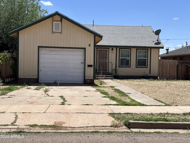 709 W Maple St, Winslow, AZ 86047 - view of front of home featuring fence, a shingled roof, an attached garage, and driveway
