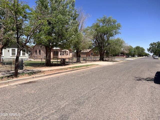 709 W Maple St, Winslow, AZ 86047 - view of asphalt street featuring sidewalks and curbs
