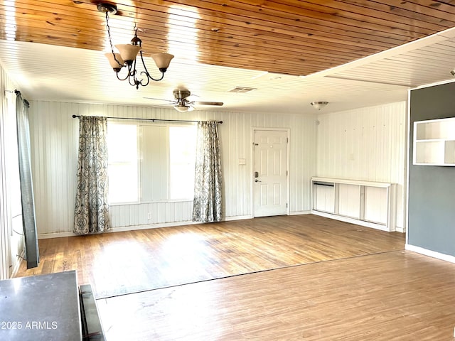 709 W Maple St, Winslow, AZ 86047 - unfurnished living room featuring ceiling fan, wood finished floors, a chandelier, wooden ceiling, and baseboards