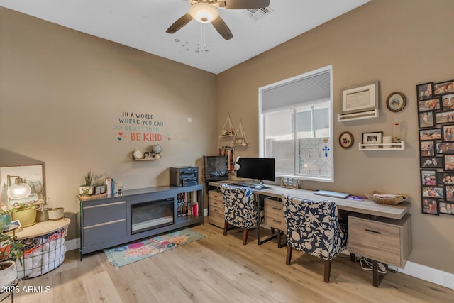 home office with a ceiling fan, visible vents, and wood finished floors