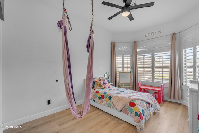 bedroom featuring baseboards, a ceiling fan, and wood finished floors
