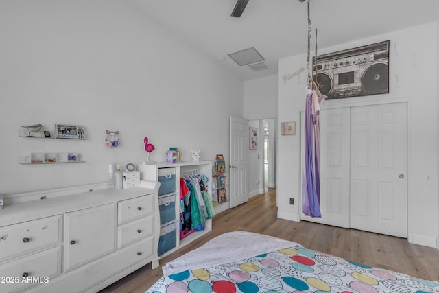 bedroom featuring visible vents, a ceiling fan, baseboards, and wood finished floors