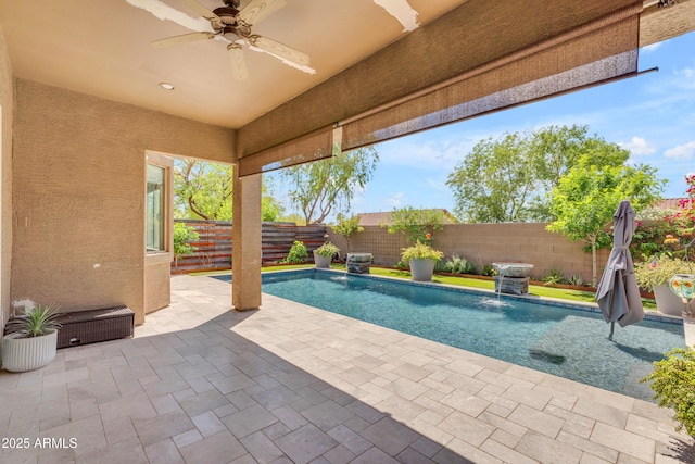 view of pool with a fenced backyard, a ceiling fan, a patio, and a fenced in pool