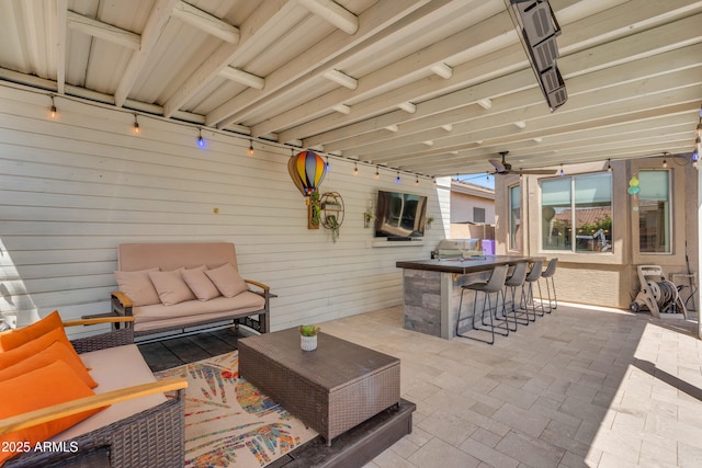 view of patio with outdoor lounge area and outdoor dry bar